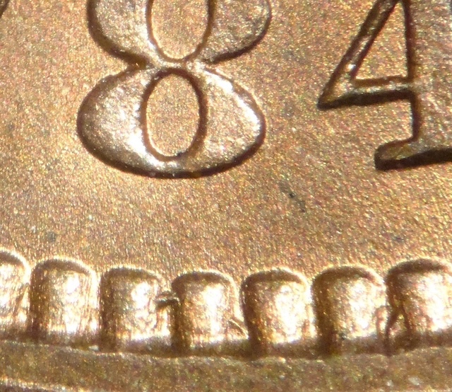 1884 Indian Head penny ODD-001 Star Reverse variety showing star-shaped hub-through artifact at the upper left of the shield on the reverse
